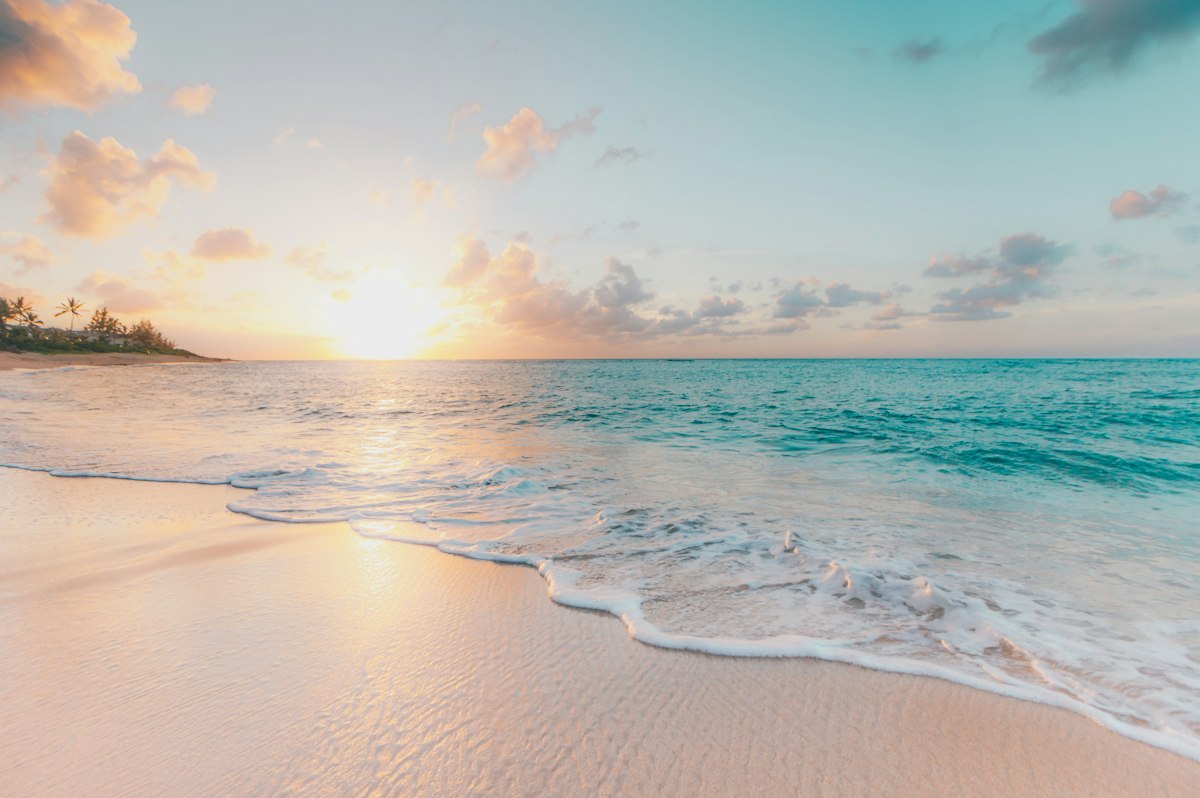 Golden beach light over a turquoise Caribbean sea